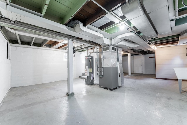 basement featuring heating unit and gas water heater