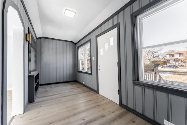 entrance foyer featuring crown molding and light wood-type flooring