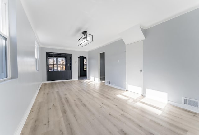 unfurnished room featuring light hardwood / wood-style floors and crown molding