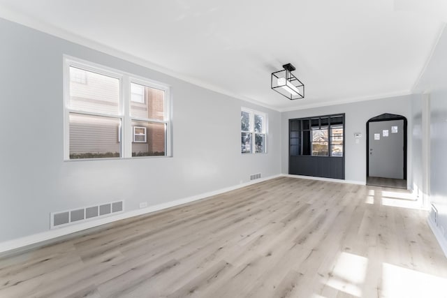 spare room with light hardwood / wood-style floors and ornamental molding