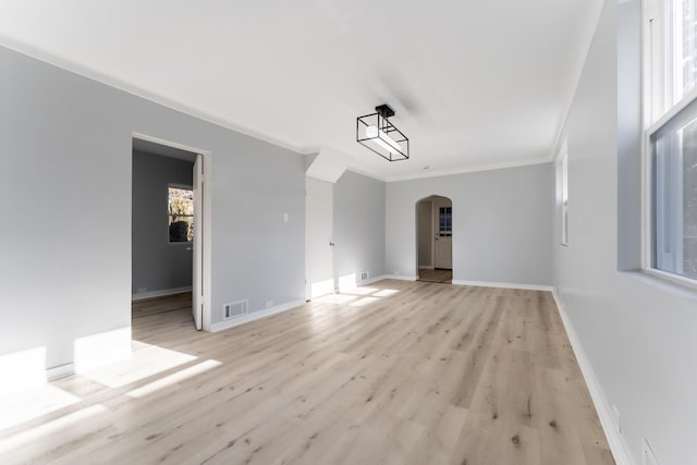 spare room with crown molding and light hardwood / wood-style floors