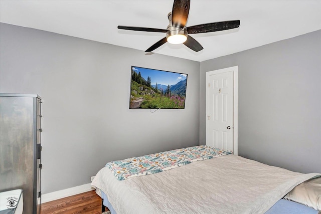 bedroom with wood-type flooring and ceiling fan