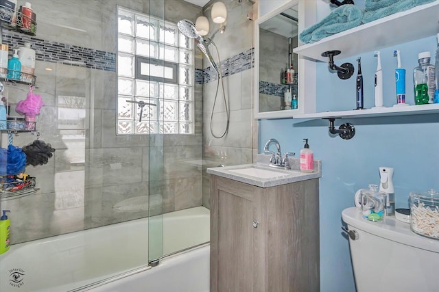 full bathroom with vanity, enclosed tub / shower combo, and toilet