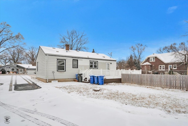 snow covered property with a deck