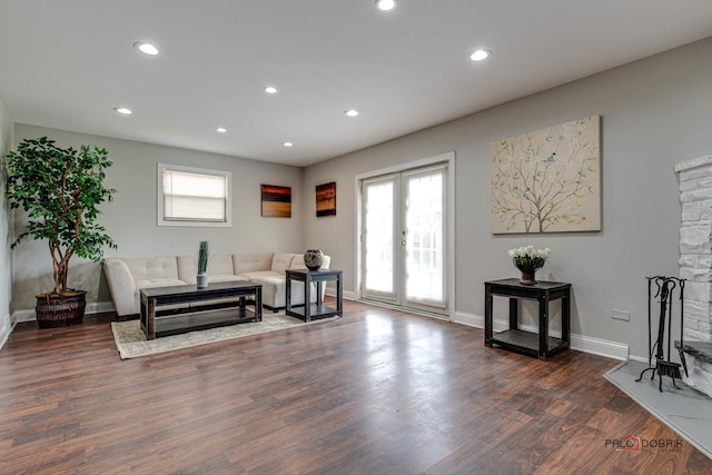 living area with dark hardwood / wood-style floors and french doors