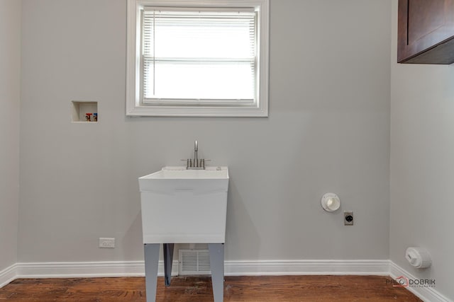 clothes washing area with washer hookup, electric dryer hookup, and hardwood / wood-style floors