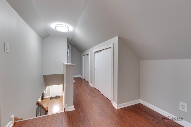 bonus room featuring vaulted ceiling and dark hardwood / wood-style floors