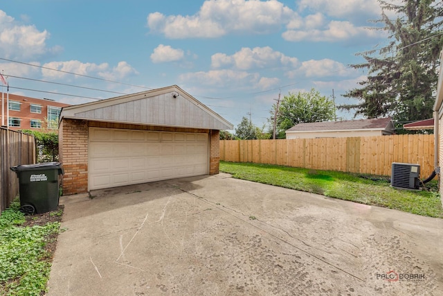 garage featuring central AC unit and a yard