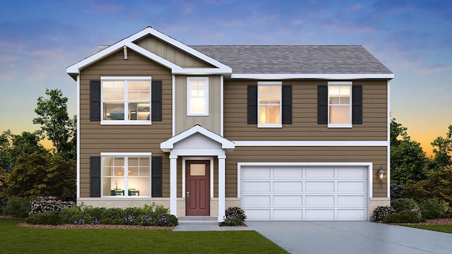 view of front of property featuring a garage and a lawn