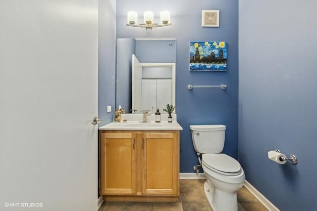 bathroom with vanity, toilet, and tile patterned floors