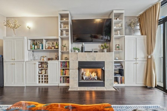 unfurnished living room with dark hardwood / wood-style floors and a tile fireplace