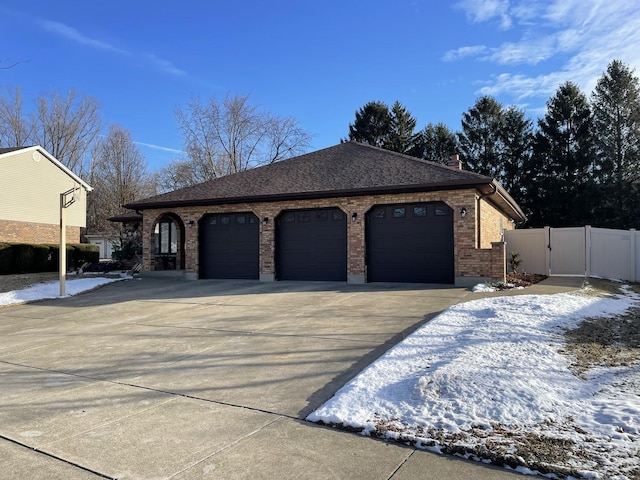 view of snowy exterior featuring a garage