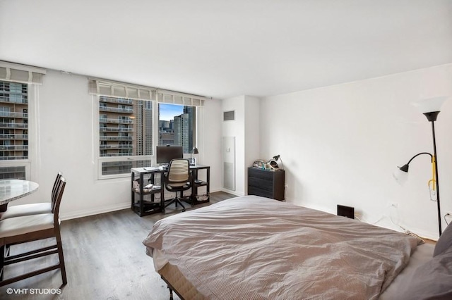 bedroom with dark wood-type flooring