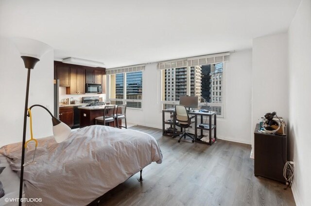 bedroom with dark hardwood / wood-style flooring