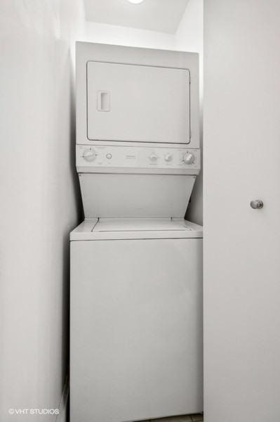 laundry area featuring stacked washer / drying machine