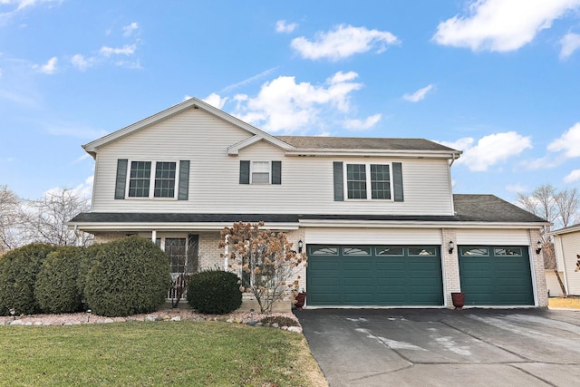 view of front property with a garage and a front yard