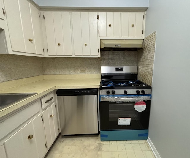 kitchen with backsplash, white cabinets, and appliances with stainless steel finishes