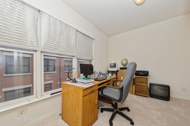 office space with light carpet and baseboards