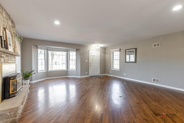 unfurnished living room featuring recessed lighting, visible vents, baseboards, and dark wood-style floors