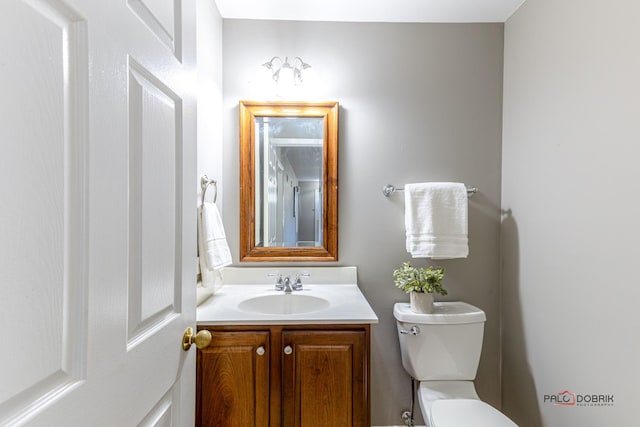 half bath featuring toilet and vanity