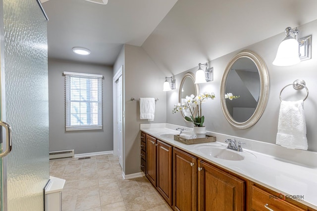 bathroom with a sink, baseboard heating, double vanity, and tile patterned flooring