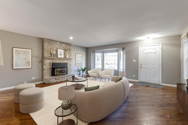 living area with a fireplace, recessed lighting, wood finished floors, and baseboards