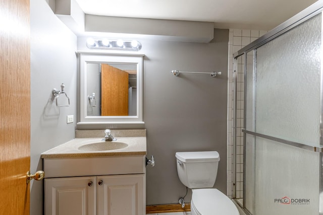 full bathroom featuring an enclosed shower, toilet, and vanity