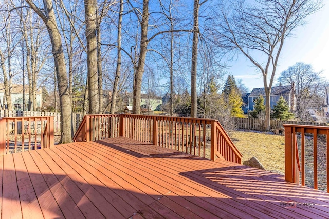 wooden terrace featuring fence