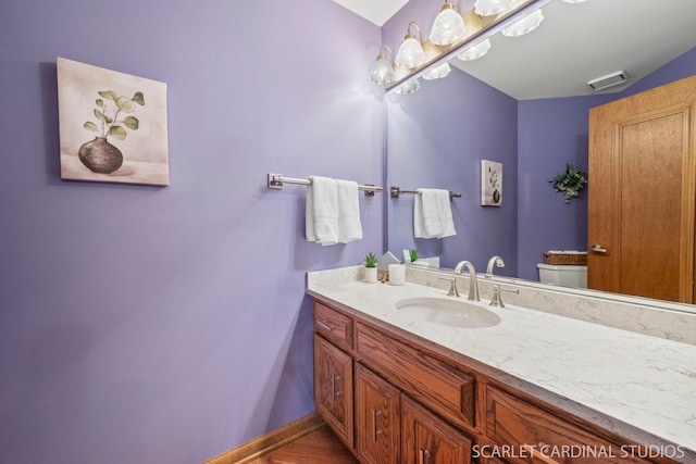 bathroom with vanity and toilet