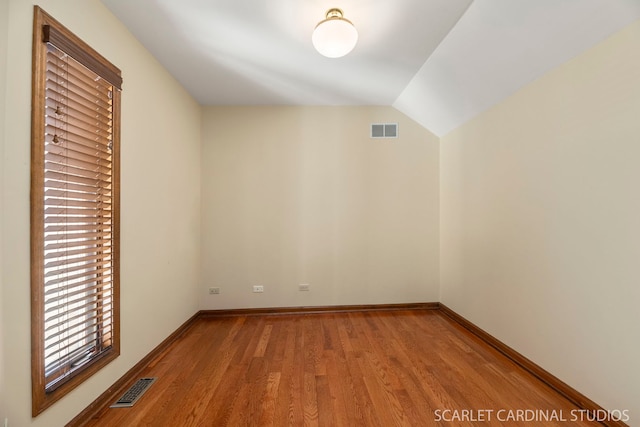 bonus room featuring lofted ceiling and light hardwood / wood-style flooring