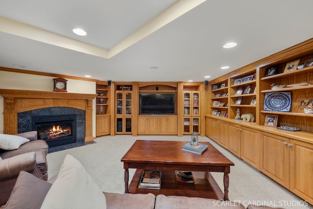 carpeted living room featuring a high end fireplace