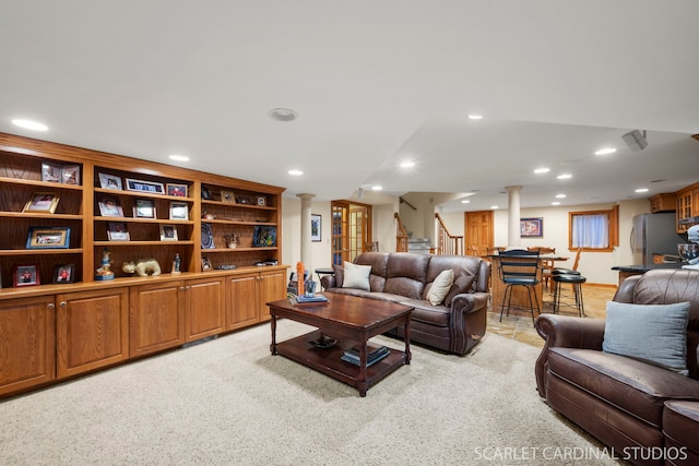 carpeted living room featuring ornate columns