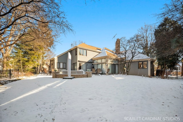 view of snow covered back of property