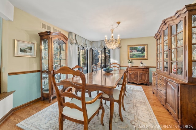 dining room featuring a chandelier and light hardwood / wood-style floors