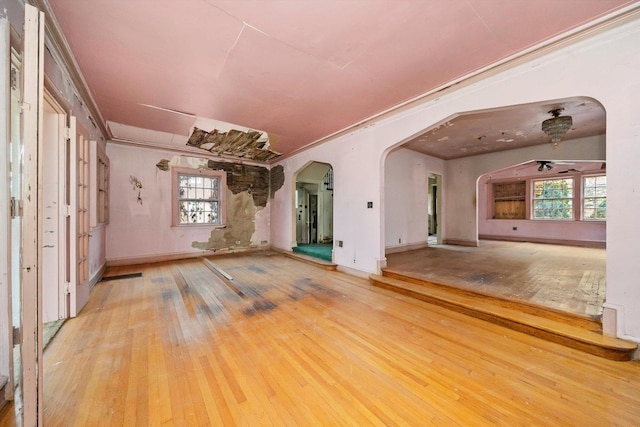 empty room with light hardwood / wood-style flooring and crown molding