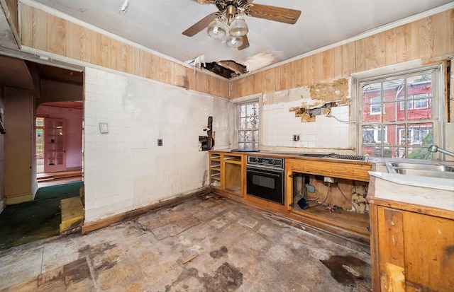 kitchen with ceiling fan, sink, plenty of natural light, and oven