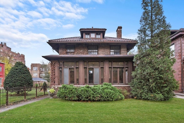 view of front of property with a front lawn and a sunroom