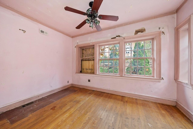 unfurnished room featuring light wood-type flooring, ceiling fan, and crown molding