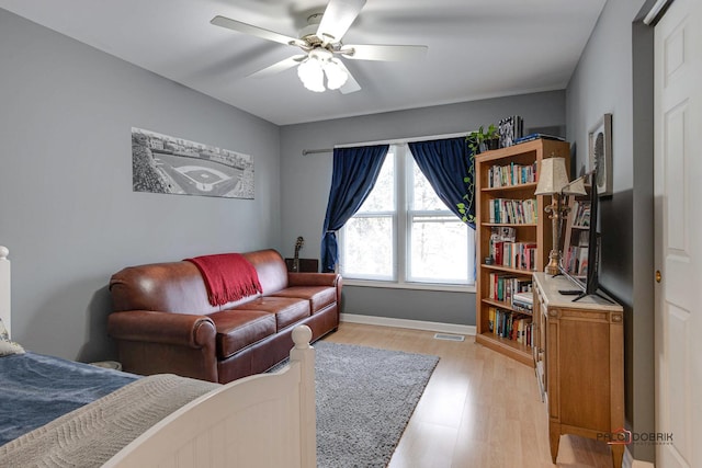 living room with ceiling fan and light wood-type flooring