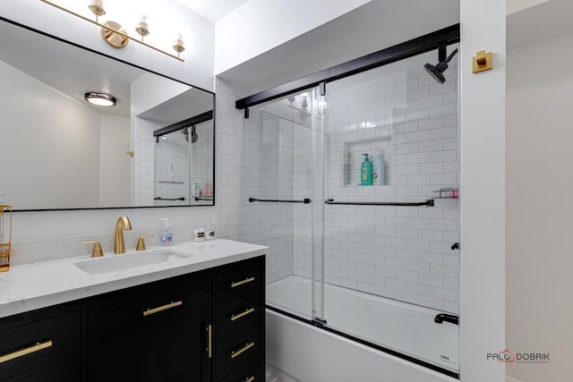 bathroom featuring enclosed tub / shower combo and vanity