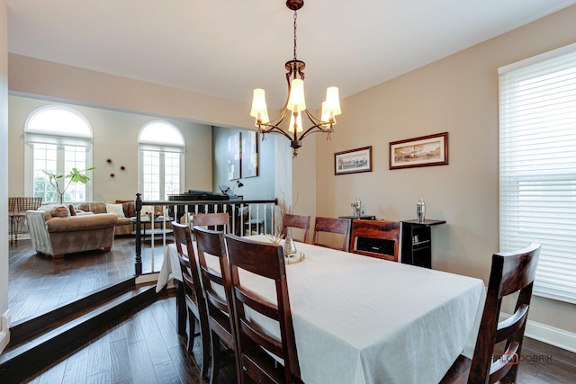 dining area featuring a notable chandelier and dark hardwood / wood-style floors