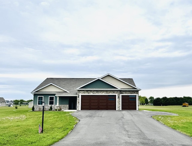 11875 Fox Trl, Wheatfield, IN 46392 - craftsman-style home with stone siding, a garage, asphalt driveway, a front yard, and board and batten siding