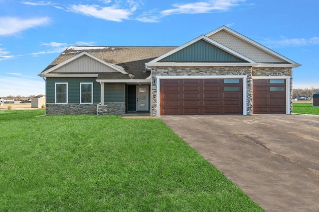 craftsman-style house with a garage and a front lawn