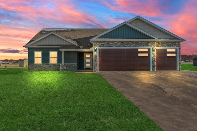 11875 Fox Trl, Wheatfield, IN 46392 - view of front of property with stone siding, a garage, driveway, and a yard