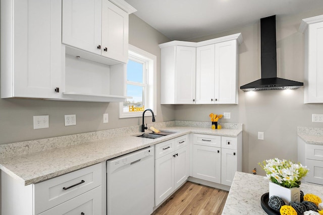 kitchen featuring sink, white cabinets, dishwasher, and wall chimney exhaust hood