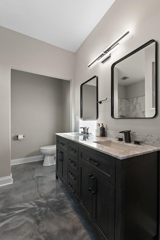 bathroom featuring vanity, toilet, and concrete floors