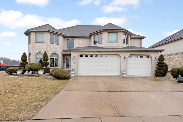 view of front of home featuring a garage and a front lawn