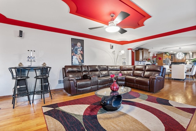 living room featuring ceiling fan and hardwood / wood-style floors