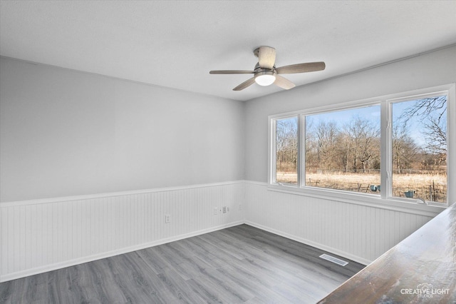 empty room featuring hardwood / wood-style floors and ceiling fan