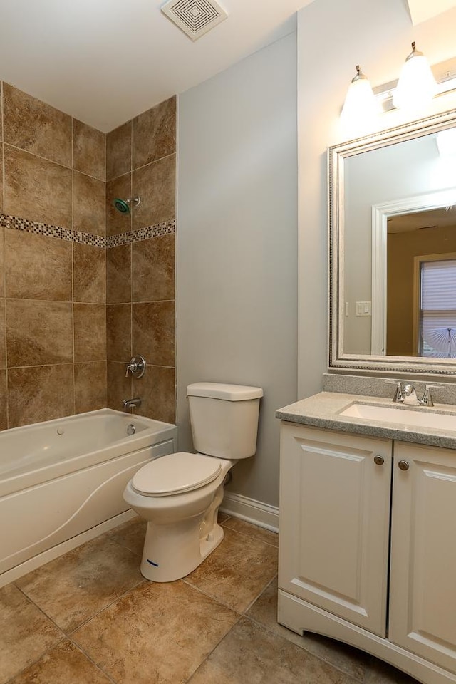 full bathroom with vanity, toilet, and tiled shower / bath